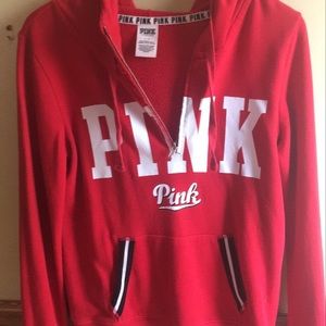A red, pink, half zip hoodie